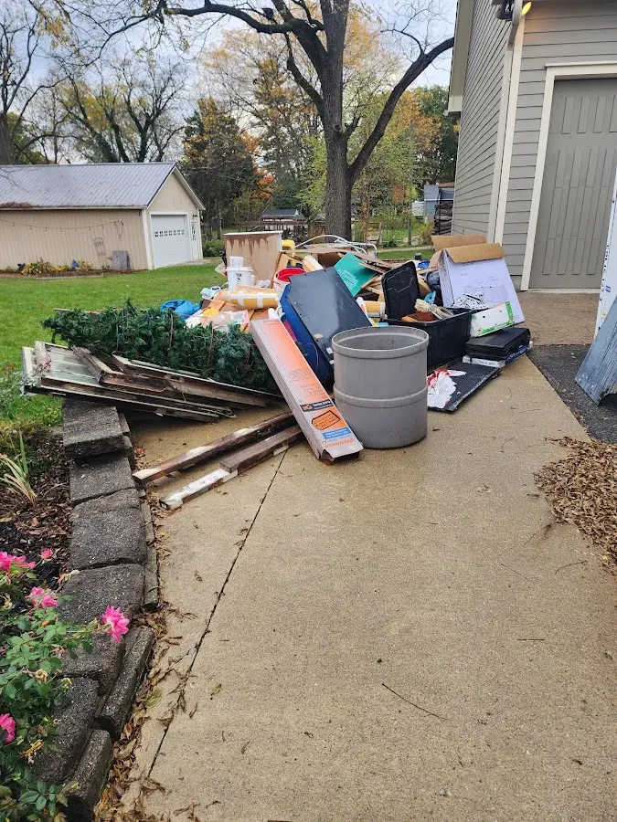Dumpster being loaded with debris for Demolition Dumpster Rental in Buckner